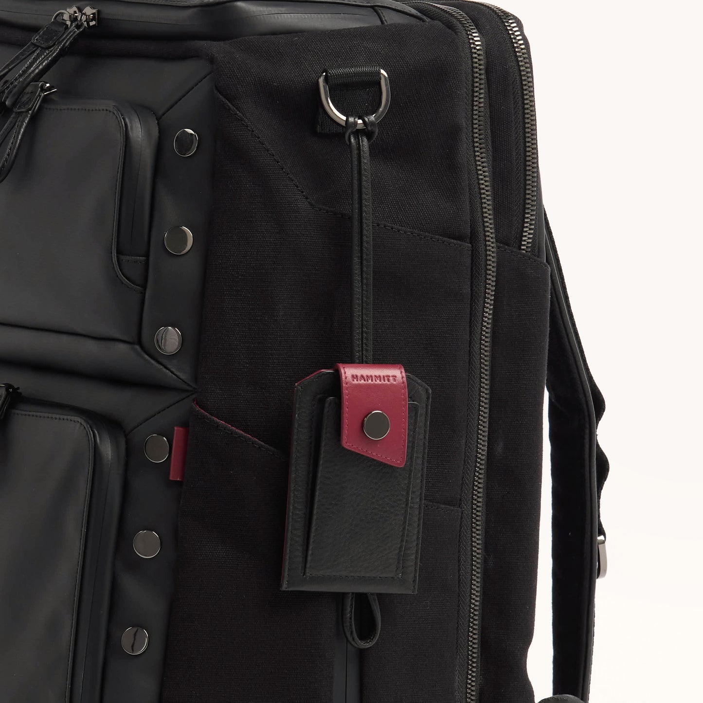 Larkspur-Luggage-Tag-Black-Leather-Swatch-Hanging-From-Burbank-Backpack.