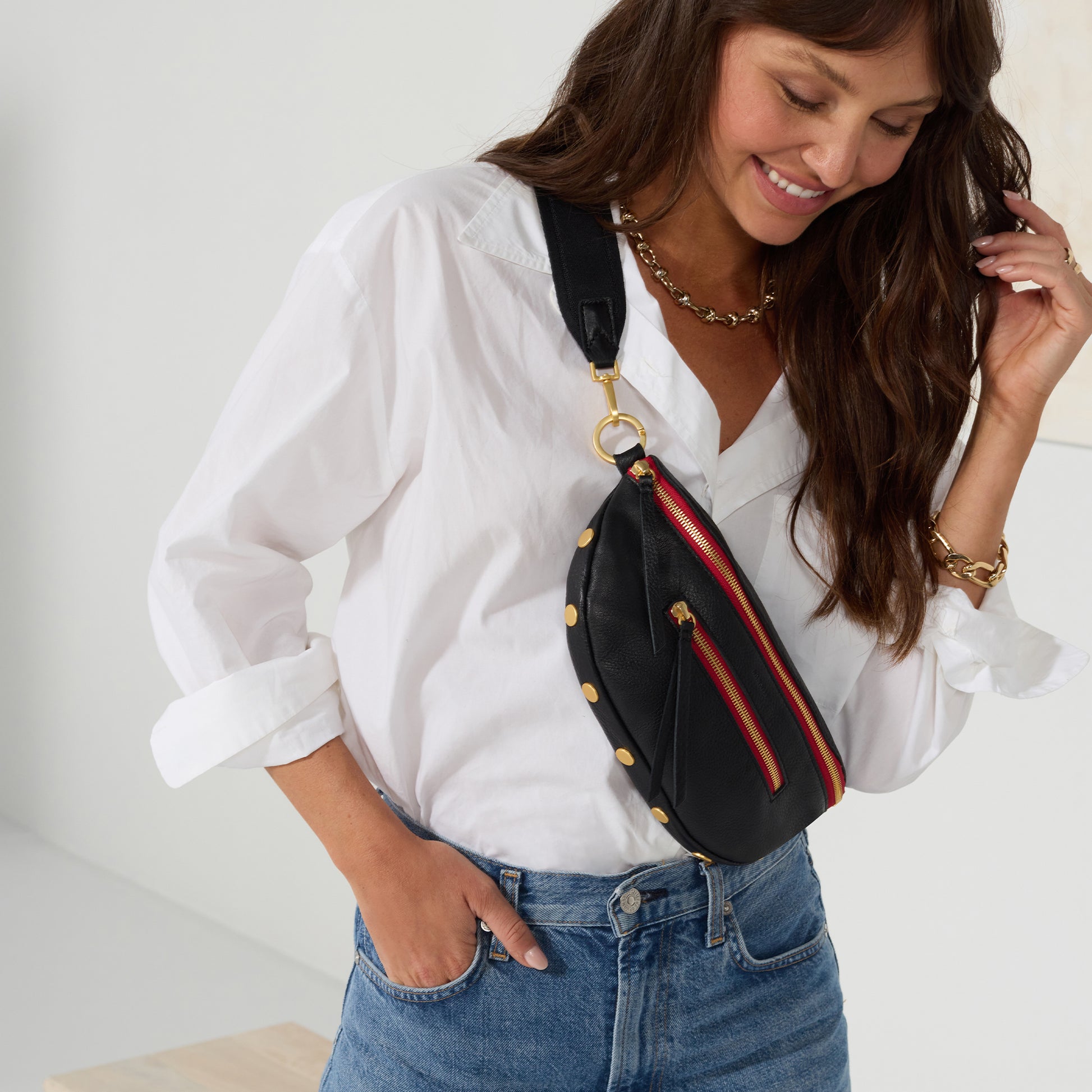 Charles-Crossbody-Black-Brushed-Gold-Red-Zip-Lifestyle-View-On-Model