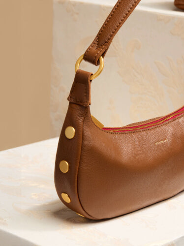 Detail image of Becker in Mahogany Pebble Brushed gold red zip showing Brushed gold rivets on side. 